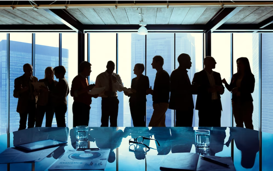 A silhouette of businessmen networking with each other to showcase how to build networking skills